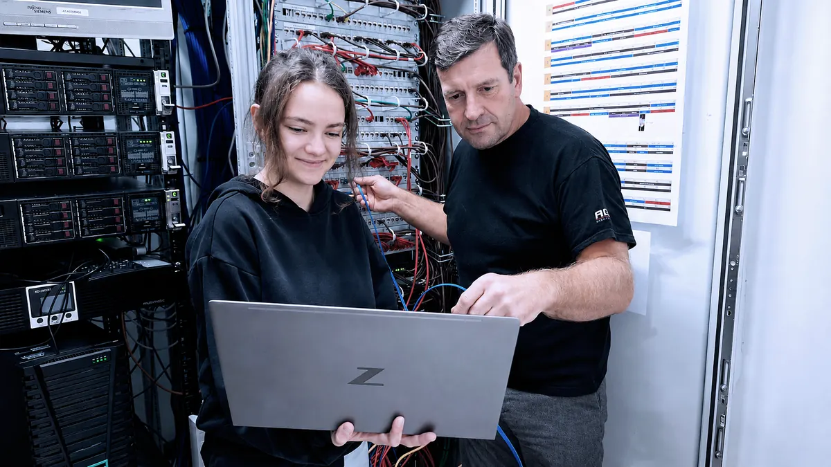 Application development apprentice with instructor in the server room