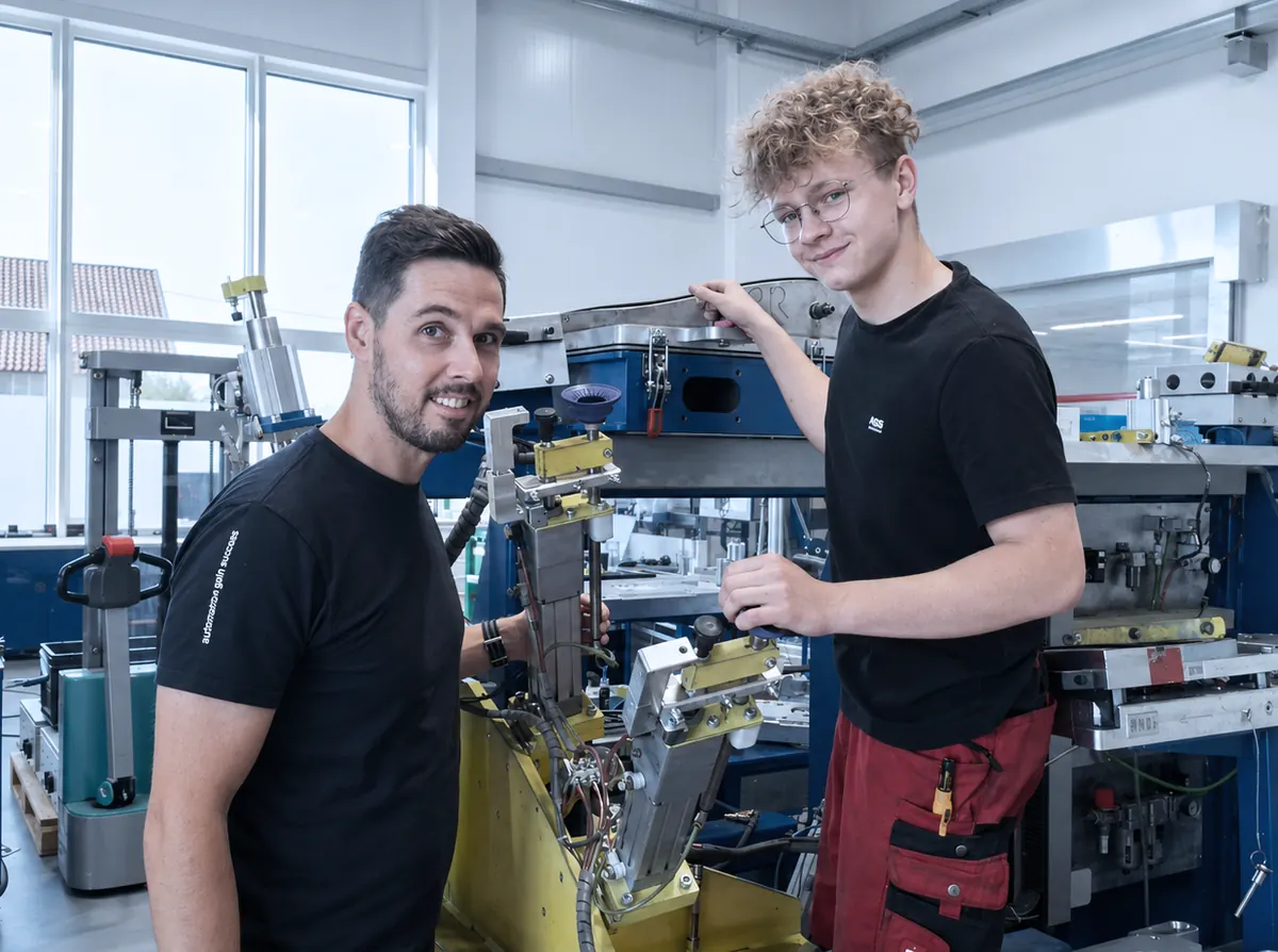 Metal technology apprentice with instructor at a fixture